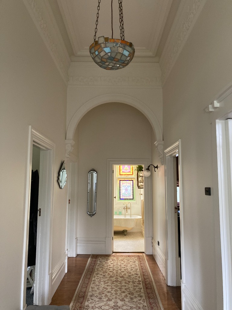 Whitsun premium completed elegant period home hallway renovation featuring high ceilings, ornate archway, and decorative cornices